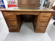 20th cent. Mahogany double pedestal desk, four drawers either side with carved handles, green