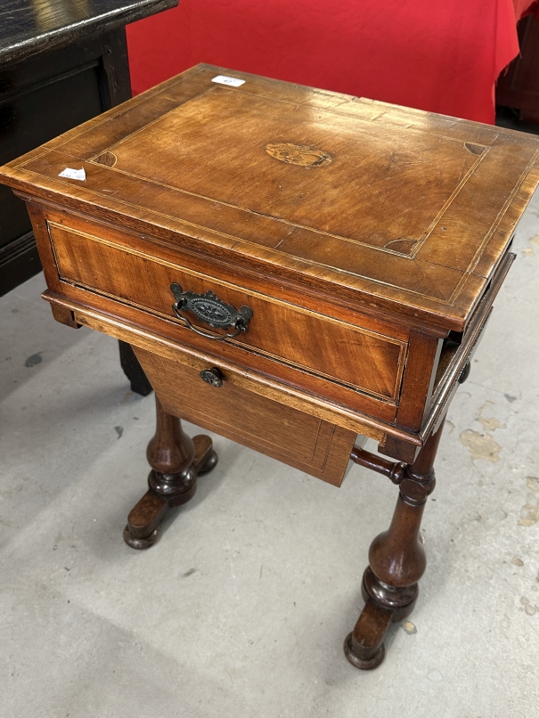 19th cent. Mahogany sewing table with inlaid oval motif above a drawer for sewing requisites. 18ins.