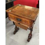 19th cent. Mahogany sewing table with inlaid oval motif above a drawer for sewing requisites. 18ins.