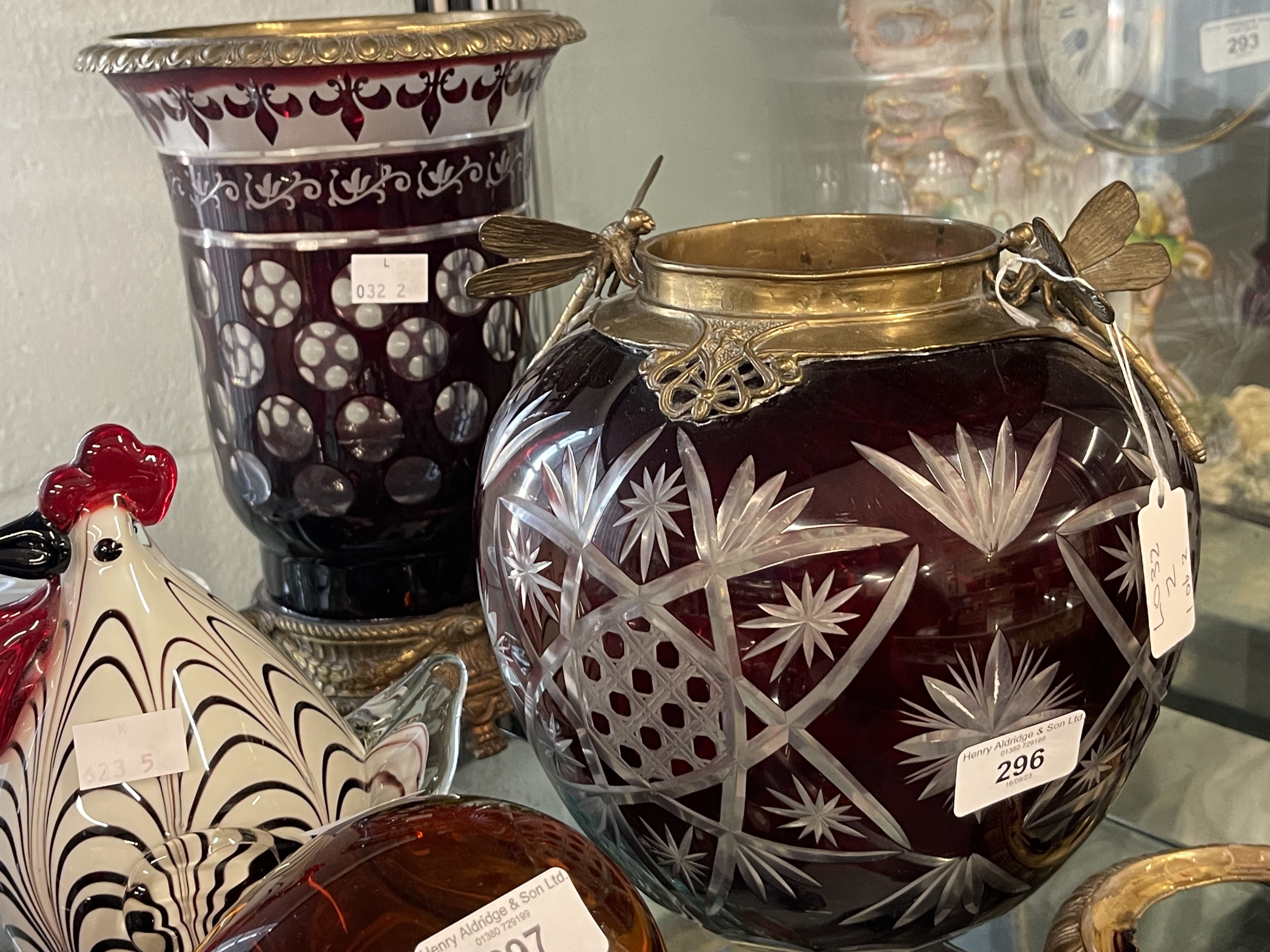 Art Glass: Late 19th cent. Red flash glass vase with star cut decoration, bronze base and collar