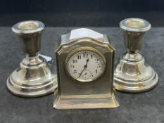 Hallmarked Silver: Pair of mantel sticks and small mantel clock. Gross weight 15.6oz.