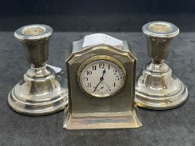 Hallmarked Silver: Pair of mantel sticks and small mantel clock. Gross weight 15.6oz.