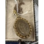 Jewellery: Large Victorian engraved yellow metal and pearl locket on a 9ct gold 19ins chain.