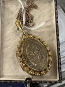 Jewellery: Large Victorian engraved yellow metal and pearl locket on a 9ct gold 19ins chain.
