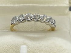 Hallmarked Jewellery: 18ct gold seven stone diamond half hoop ring, known weight of diamonds 0.55ct.