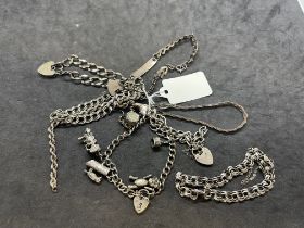 Hallmarked Jewellery: Eight silver chain bracelets one with six assorted charms. Total weight 94.