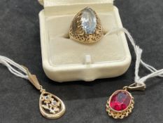 Jewellery: Yellow metal pendant set with an oval synthetic ruby, tests as 14ct gold. Weight 3.9g.