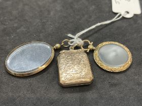 Jewellery: Three yellow metal lockets, one rectangular hinged, one oval with glass, and one round