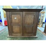 20th cent. Oak wall hanging cupboard of modest proportions, four panels to the two front doors and