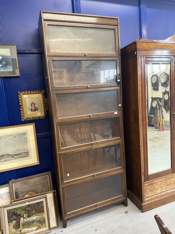 Edwardian oak Globe Werneck style six section bookcase, Adams trademark label to bottom section.