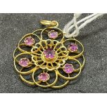 Jewellery: Yellow metal open circular pendant, floral decoration set with seven amethysts, estimated