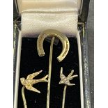 Victorian stick pins including a large horseshoe and two in, tested, unmarked gold. (3)