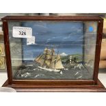 Diorama of a ship at sea with a lighthouse in the background. A/F