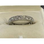 Jewellery: White metal ring set with twenty brilliant cut diamonds as a full eternity ring,