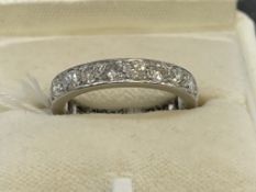 Jewellery: White metal ring set with twenty brilliant cut diamonds as a full eternity ring,