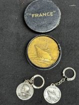 OCEAN LINER: S.S. France maiden voyage medallion plus two white metal keyrings of the same. (3)