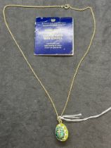 Jewellery: Yellow metal chain (18ins) with a green enamelled egg pendant attached 17.5mm x 14.5mm