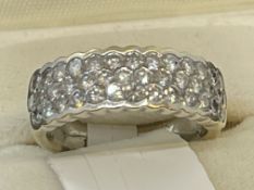 Jewellery: White metal ring, triple row half hoop set with forty brilliant cut diamonds