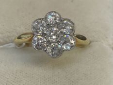 Jewellery: Yellow metal ring seven stone diamond floral cluster, estimated weight of (7) 1.10ct,