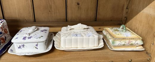 Two Staffordshire sardine dishes, both decorated with moulded fish and one butter dish.