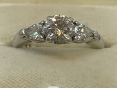 Jewellery: Platinum three stone ring centre set with a brilliant cut diamond with a pear shaped