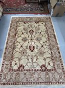 Modern weave rug, ivory colour highlighted with reds, blues and green. 81ins. x 58ins.