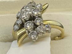 Jewellery: Yellow metal ring set with fifteen graduated brilliant cut diamonds as a fancy cluster