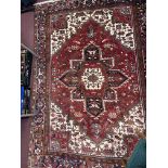 20th cent. Caucasian carpet, possibly Kazak, red ground with one central Gul, segmented greens, four
