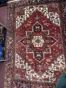 20th cent. Caucasian carpet, possibly Kazak, red ground with one central Gul, segmented greens, four