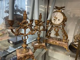 Pink marble and gilt metal French Republic clock with garniture of two, two-branch candlestcks,