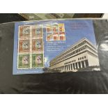 Three albums containing an eclectic mix of stamp related collectables relating to Hong Kong from