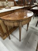 19th cent. Mahogany demi lune tea table inlaid with boxwood stringing, on tapering supports.