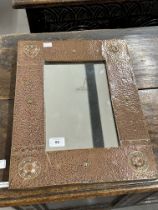 Beaten copper mirror in the style of Liberty's. 13ins. x 12ins.