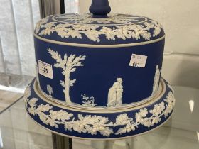 Wedgwood Jasperware cheese stand with white bas-relief classical figures. Dia. 10ins. Height 8ins.