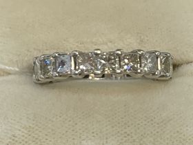 Jewellery: White metal full eternity ring set with nineteen princess cut diamonds, estimated