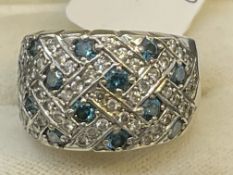 Jewellery: White metal ring in the form o a turban style cluster set with fourteen blue diamonds,