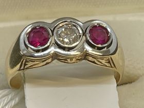 Jewellery: Diamond and ruby triology ring set with a brilliant cut diamond, estimated weight