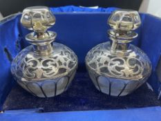 Silver/Arts and Crafts: A pair of glass cologne bottles with white metal overlay, marked D2491
