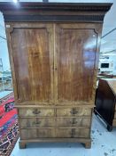 Georgian flame mahogany wardrobe on chest, two panelled doors enclosing hanging space, above two