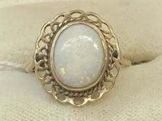 Jewellery: 9ct gold mourning ring set with an oval 1mm x 9mm opal with a pierced border