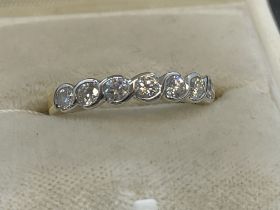 Jewellery: 18ct gold seven stone diamond half hoop ring, known weight of diamonds 0.55ct. Ring size