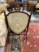 19th cent. Mahogany fire screen with needlepoint floral design within a shield.