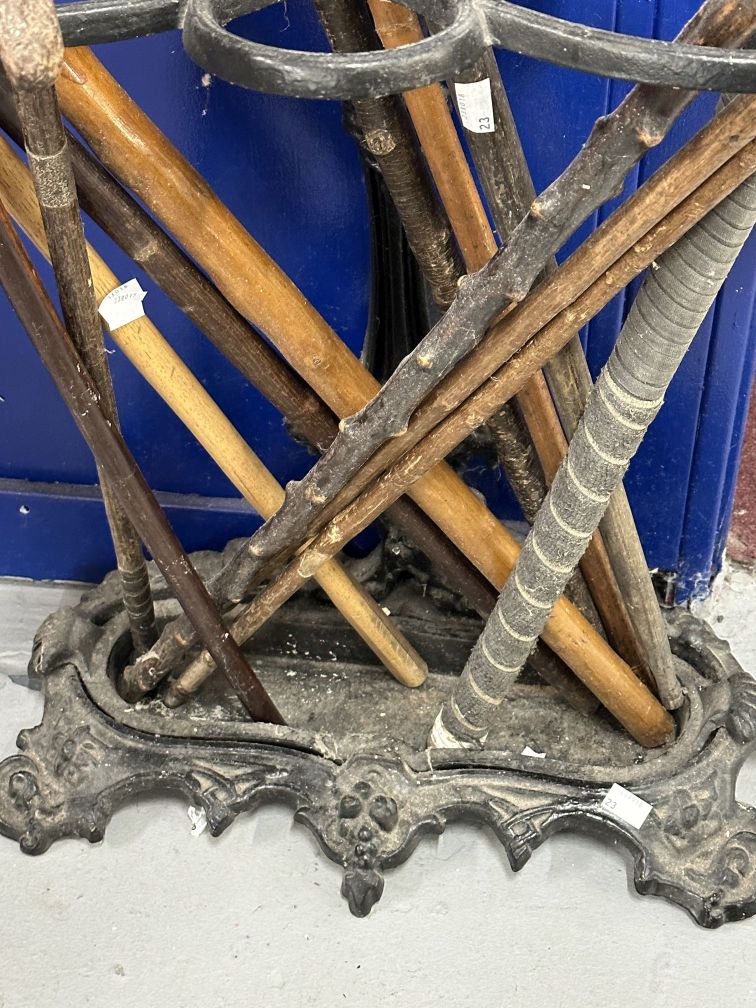 Coalbrookdale style cast iron stick stand with an assortment of wooden walking sticks, a lacrosse - Image 2 of 2