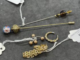 Collection of yellow metal jewellery items including link ring, Christian Dior earrings, hat pins,