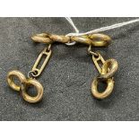 Jewellery: Yellow metal figure of eight shaped cufflinks, a pair, test as 18ct gold. Weight 5.4g.