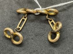 Jewellery: Yellow metal figure of eight shaped cufflinks, a pair, test as 18ct gold. Weight 5.4g.