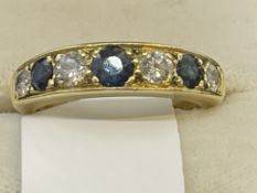 Jewellery: Yellow metal ring, seven stone half hoop set with four graduated brilliant cut diamonds,