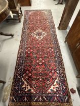 20th cent. Persian runner, red ground with one central Gul and three borders, all decorated with