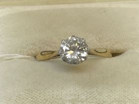Jewellery: Yellow and white metal ring claw set with a single brilliant cut diamond, estimated