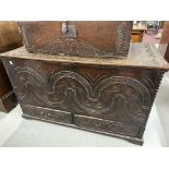 17th/18th cent. Oak mule chest with heavily carved front. 46ins. x 21ins. x 26ins.